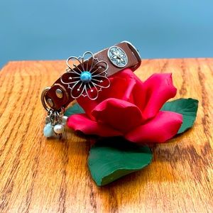 Floral and dangle charm leather bracelet in brown. Charms are stainless steel 🌼